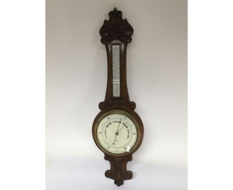 A carved oak mercury filled wall barometer.