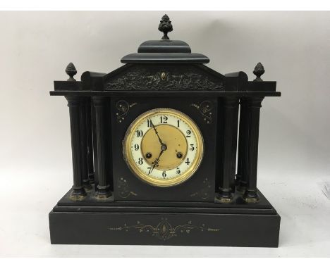 A large black slate mantel clock.