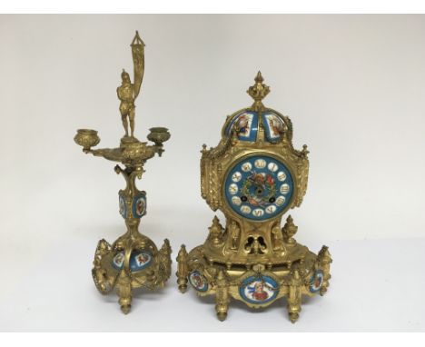 A French enamel mantle clock with a conforming candelabra, missing key and pendulum.