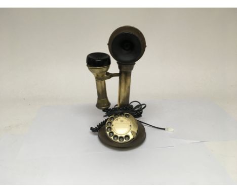 A brass stick telephone with modern cord