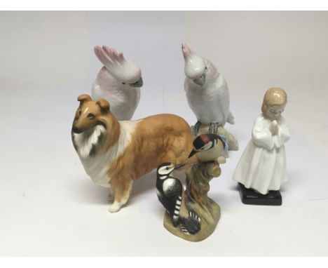 Two Royal Dux, porcelain Parrots, a Beswick dog, a Doulton figure bedtime, and Royal Worcester bone china figure group Pied W