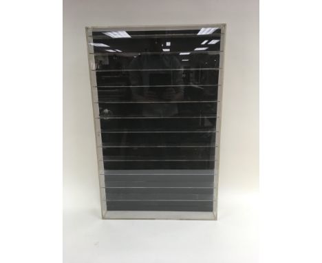 A wooden and Perspex display unit, ideal for showcasing model vehicles. 53cm wide x 8cm deep x 83cm tall.