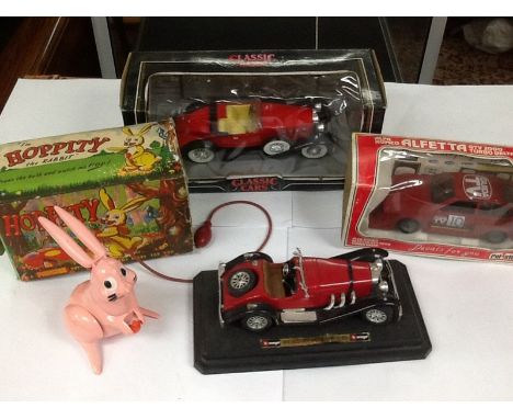 A box containing a boxed " hoppity the rabbit" and 3 other model vehicles.