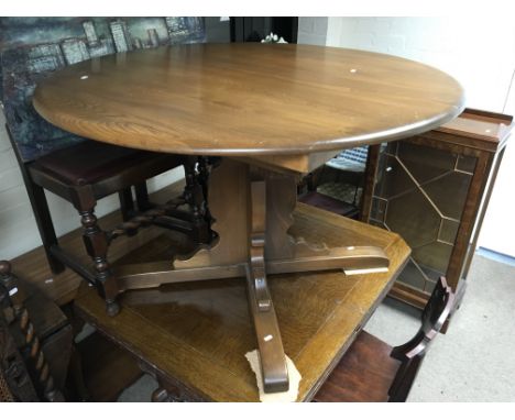 A dark wood Ercol dining table and chairs.