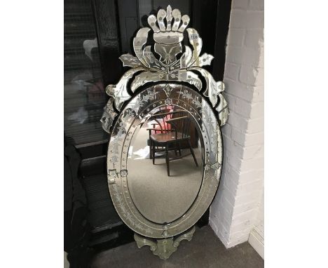 A large ornate wall hanging glass mirror. Height 55inches width 25 inches.