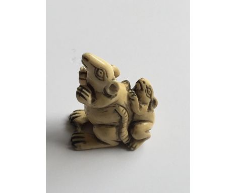 A Japanese carved Ivory Netsuke in the form of two rats signed. 4cm.