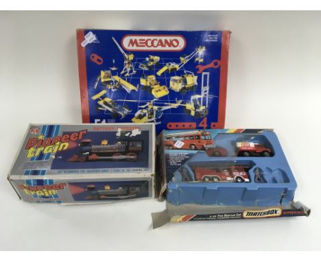 A Meccano motor Number 4 set (unopened), a Matchbox K-119 fire rescue set and a boxed battery operated tin plate pioneer trai