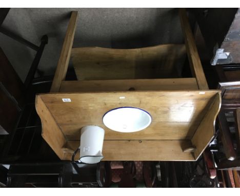 A pine wash stand inset with enamel basin and a matching enamel jug