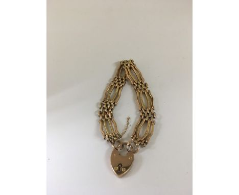 A 9ct gold gate bracelet with heart padlock