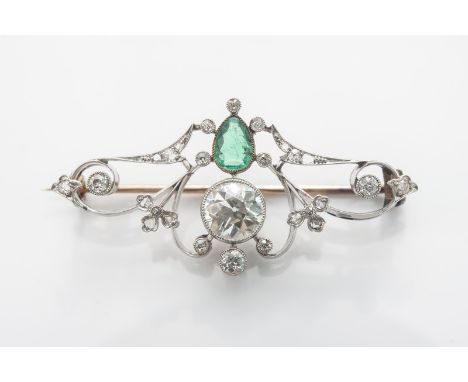 A quality vintage brooch set with diamonds and an emerald, the central old cut diamond 1.20 caret. The pear shaped emerald 0.