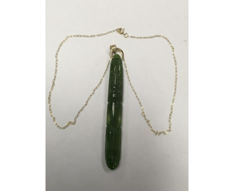 An unusual jade pendant on a 9ct gold chain.