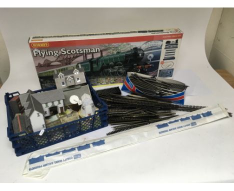 A hornby flying Scotsman train set and a Collection of OO gauge track and paper model buildings.