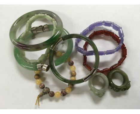 A small collection of jade and jade type bracelets and rings.
