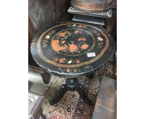 An old ebonised lacquered occasional table in tripod base