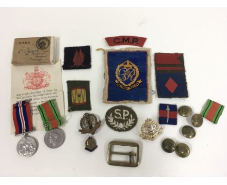Two WW2 medals and various military police badges and buttons