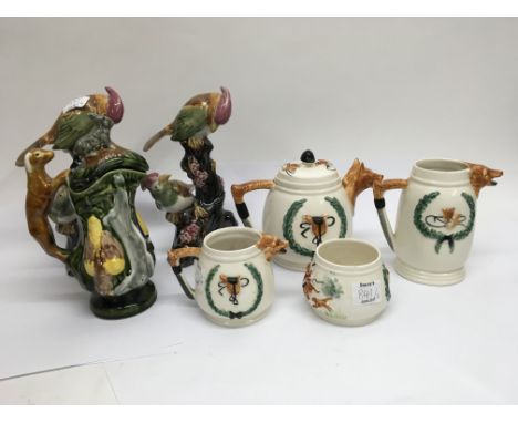 A PPC 4 piece hunting scene tea set plus a pair of majolica style bird ornaments and a jug decorated with animals.