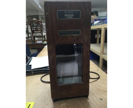 An Evershed and Vignoles pen recorder with continuous roll charts, housed in a wooden case with a cast iron base