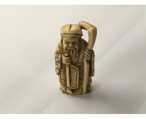 A Japanese carved Ivory Netsuke in the form of an elder with applied colour decoration possible late Meiji Period. Signed bas