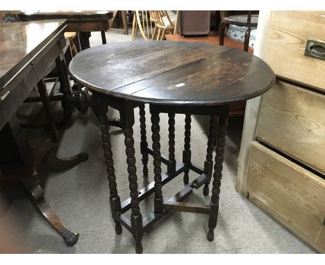 A small oak drop flap occasional table with bobbin turned legs, approx 66.5cm x 54.5cm x 66cm and a sabre legged stool with t