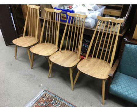 A set of four light wood Ercol Goldsmith chairs.