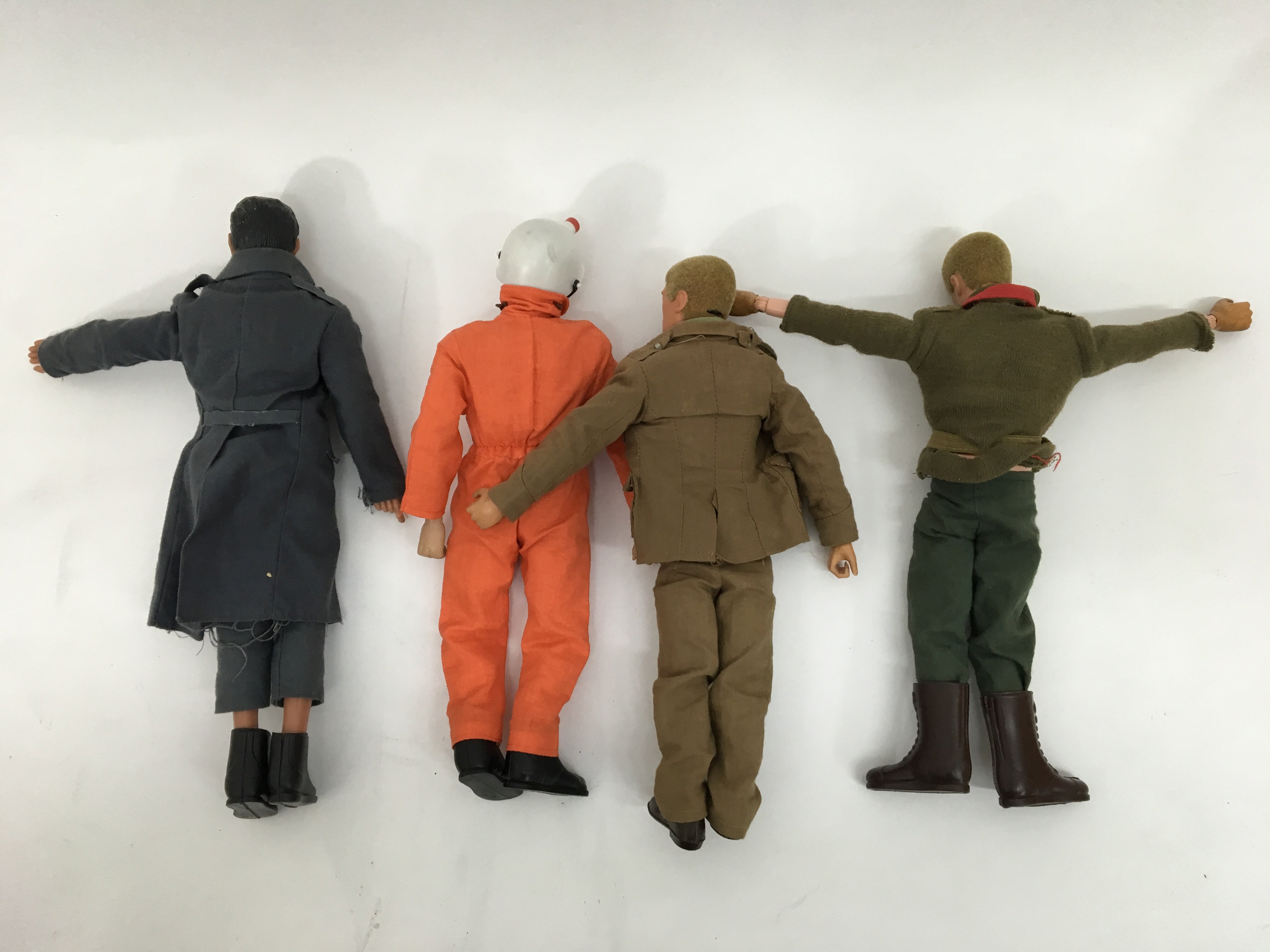 A collection of 4 unboxed action man figures; three of which are early