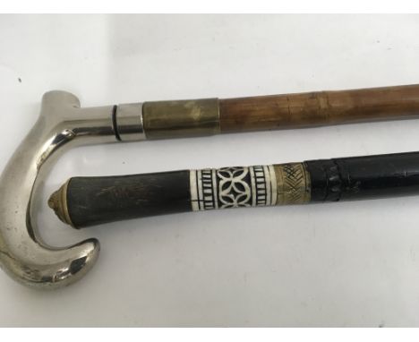 A Indian sword stick and one other with silver handle