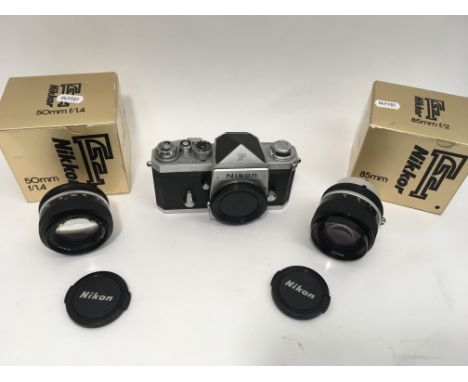 A rare 1960's Nikon F silver and black camera body with eye level prism, with a boxed 50mm f1.4 lens and 85 mm f2 lens, boxed