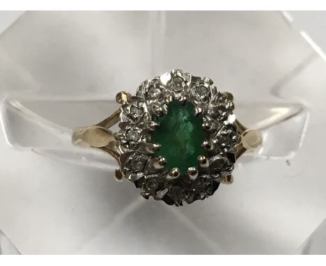 A 9ct gold ring set with an emerald surrounded by small diamonds, approx 2.2g and size K.