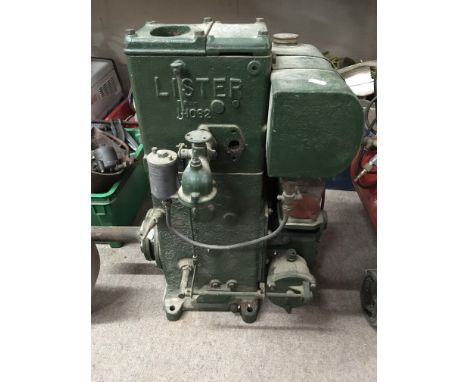 A Lister stationary engine 1-1026 with flywheel detached in need of full restoration