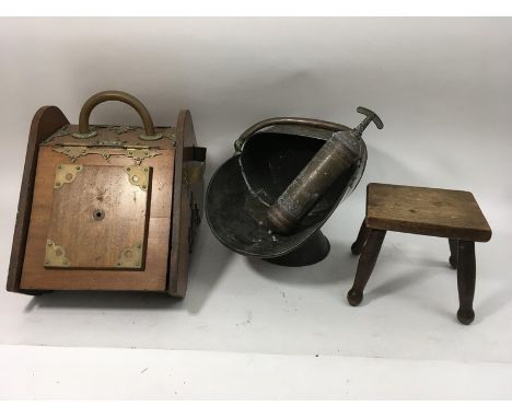 A walnut coal box, a metal coal scuttle, a fire extinguisher and a small stool.