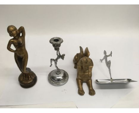 Four pieces of Art Deco items including a figure of a woman and a sphinx.