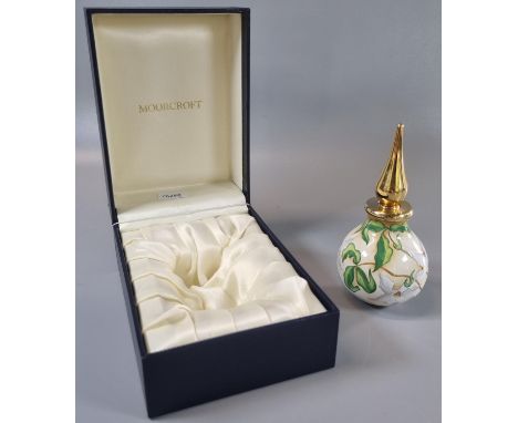 Modern Moorcroft enamel perfume bottle and stopper decorated with magnolia on an ivory ground.  Printed factory marks to the 