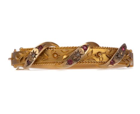 RED GEM SET AND DIAMOND BANGLE,with three overlaid gem set and diamond sections interspaced by foliate decoration, in nine ca