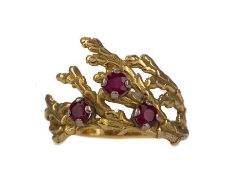 CONTEMPORARY RUBY RING,set with three round rubies to a foliate motif shank, in eighteen carat gold, size K, 4.2g