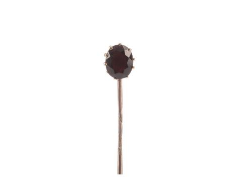 GARNET STICK PIN,set with an oval garnet, unmarked, 2.7g