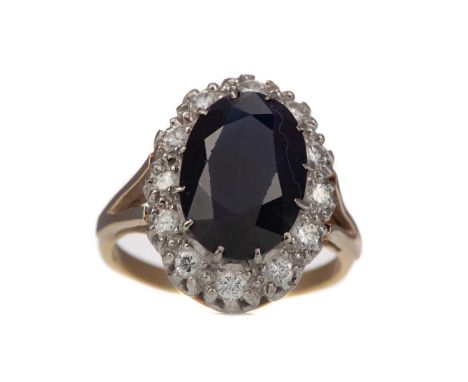 SAPPHIRE AND DIAMOND CLUSTER RING,the oval sapphire 14mm long, within a round brilliant cut diamond halo totalling approximat