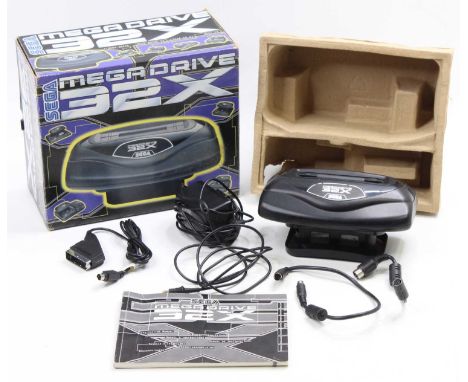 A Sega Megadrive 32X console add-on, housed in the original card box, with instruction leaflet