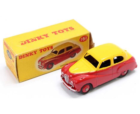 Dinky Toys No. 161 Austin Somerset saloon comprising of two tone red and yellow body with red hubs, the model has a few small