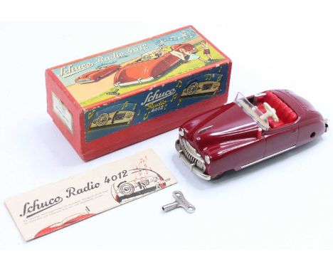 Schuco No. 4012 tinplate and clockwork radio car, maroon body, red interior, 2 clockwork motors to operate radio and drive, i