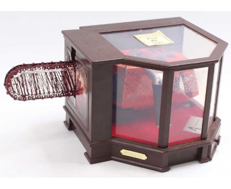 An original Play Station 2 Capcom Resident Evil Four limited edition chain saw controller, housed in the original wood-effect