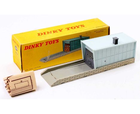French Dinky Toys No. 502 Garage, finished in pale grey-blue, and grey, sold in its original yellow pictorial card box, with 