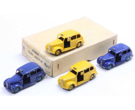 An original Dinky Toys trade box of No. 40H six Austin taxis containing two yellow and two dark blue examples, housed in the 