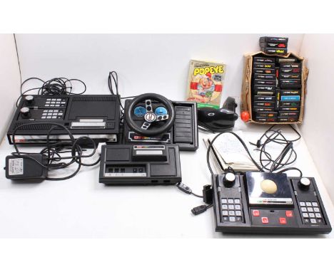A large box containing a collection of Coleco Vision consoles, expansion packs, steering wheels, various leads, roller contro