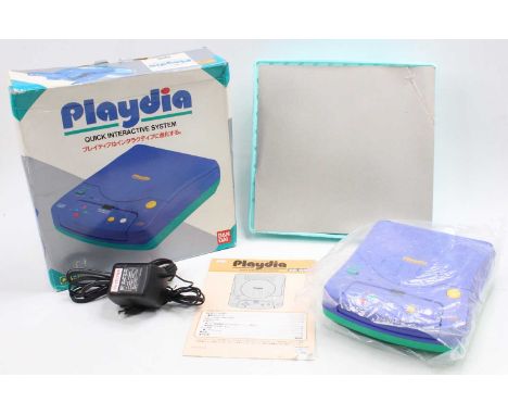 A Bandai Playdia Quick Interactive Gaming System, housed in the original card box, appears complete with inner sliding tray p