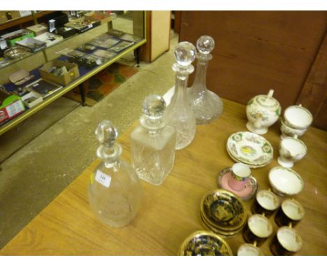 An etched glass decanter and stopper; together with three other decanters 