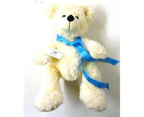 A Steiff bear with a blue ribbon