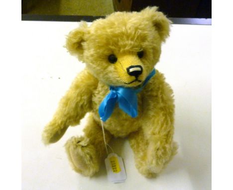 A Steiff bear with a blue ribbon 