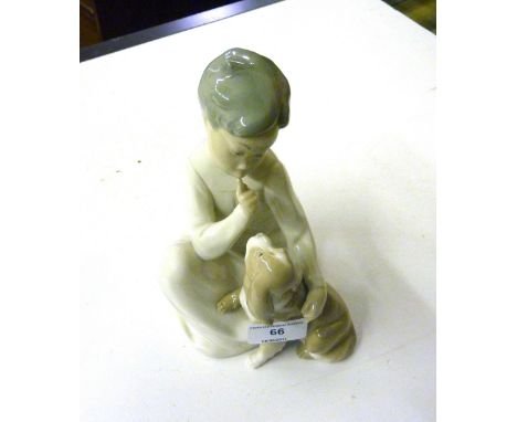 A Lladro figure in the form of a child with a dog 
