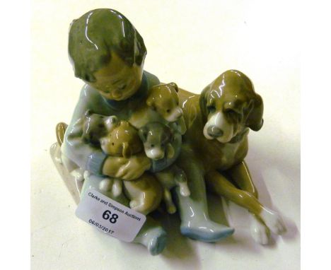 A Lladro figure group in the form of a child with a dog and puppies