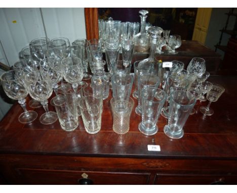 A quantity of various drinking glasses; and a decanter and stopper
